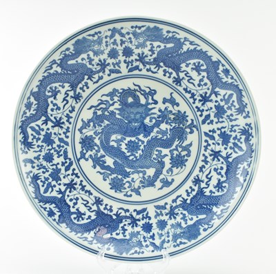 Lot 79 - EARLY 20TH CENTURY CHINESE BLUE AND WHITE DRAGON CHARGER