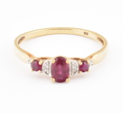 Lot 323 - HALLMARKED 9CT GOLD RUBY & DIAMOND THREE STONE RING