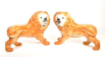Lot 100 - EARLY 20TH CENTURY STAFFORDSHIRE FIRESIDE CERAMIC LION ORNAMENTS