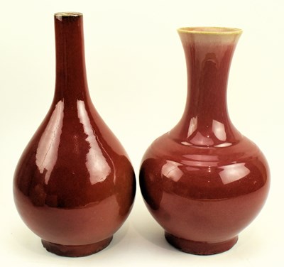 Lot 82 - TWO CHINESE SANG DE BOEUF FLAMBE VASES 郎红釉胆瓶和天球瓶一组