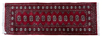 Lot 557 - 20TH CENTURY PERSIAN BOKHARA WOOLLEN CARPET RUNNER RUG