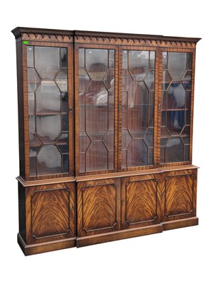 Lot 776 - GEORGE III REVIVAL FLAME MAHOGANY BREAKFRONT LIBRARY BOOKCASE