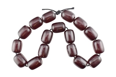 Lot 329 - STRING OF CHERRY AMBER BAKELITE BEADS