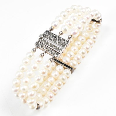 Lot 138 - A SILVER THREE STRAND PEARL BRACELET WITH MARCASITE CLASP
