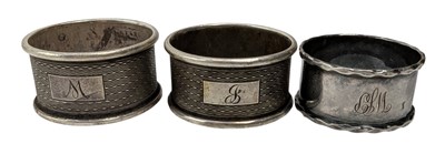 Lot 138 - THREE 20TH CENTURY GEORGE V HALLMARKED SILVER NAPKIN RINGS