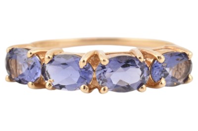 Lot 167 - HALLMARKED 14CT GOLD & TANZANITE FOUR STONE RING