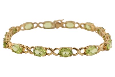 Lot 228 - HALLMARKED 9CT GOLD PERIDOT TENNIS LINE BRACELET
