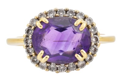 Lot 75 - 18CT GOLD AMETHYST & DIAMOND HALO RING
