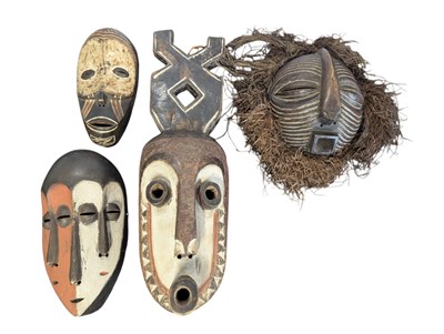 Lot 471 - COLLECTION OF FOUR DECORATIVE CONGOLESE HAND-CARVED WOODEN TRIBAL MASKS