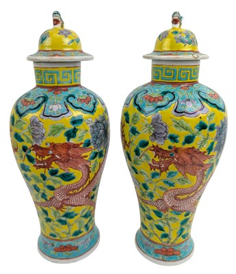 Lot 16 - PAIR OF 19TH CENTURY CHINESE LIDDED URNS 清 黄地龙穿牡丹盖罐一对
