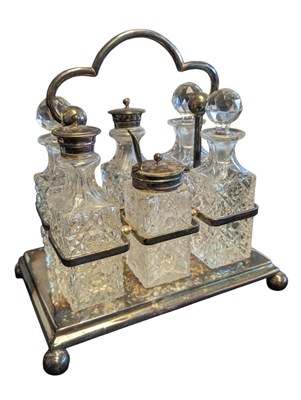 Lot 261 - EDWARDIAN CONDIMENT CRUET SET ON SILVER PLATED CARRY TRAY