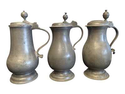 Lot 397 - THREE EARLY 19TH CENTURY LARGE PEWTER LIDDED JUGS