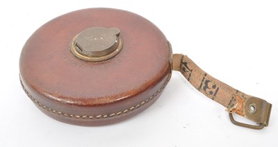 Lot 238 - SET OF TWO 1960S LEATHER CASED SURVEYOR TAPE MEASURES