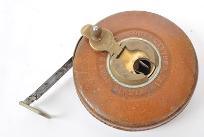 Lot 238 - SET OF TWO 1960S LEATHER CASED SURVEYOR TAPE MEASURES