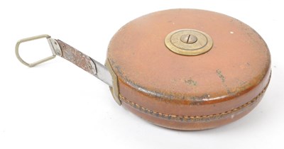 Lot 238 - SET OF TWO 1960S LEATHER CASED SURVEYOR TAPE MEASURES