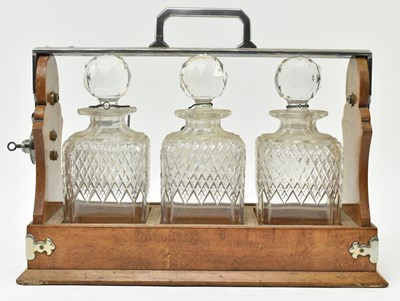 Lot 156 - 19TH CENTURY SILVER PLATED & OAK THREE CUT GLASS DECANTERS TANTULUS